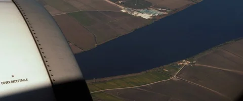Aerial view of the river and landscape from the window of an airplane Stock Footage 127135261