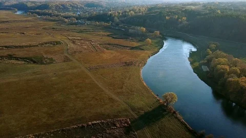 Aerial view of river and meadows in autumn Stock Footage 127111792