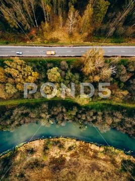Aerial view of river and road in autumn color forest Stock Photos