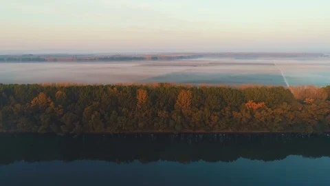 Aerial view of a river and some fields amidst a thick fog. Stock Footage 114429533