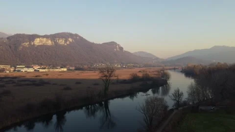 Aerial view of a river with bare trees at sunset Stock Footage 166527510