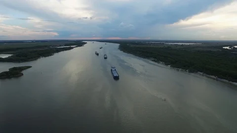 Aerial view: river, barges, blue sky reflected in the water Video stock 123077413