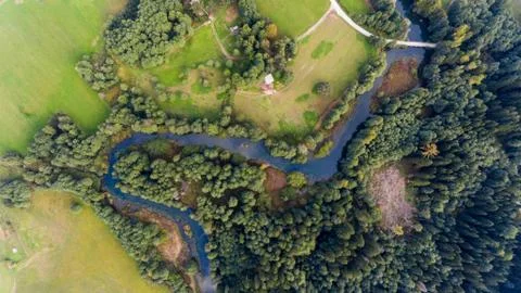 Aerial view of river bend through forest. Stock Photos