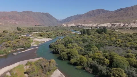 Aerial view of river bends and red hills, Kok-Moinok, Kyrgyzstan Видео 347239794