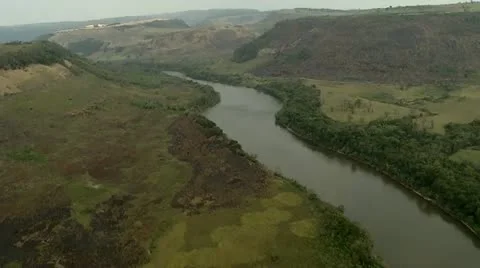 Aerial view of a river between the rainforest and the meadow Stock Footage 12013134