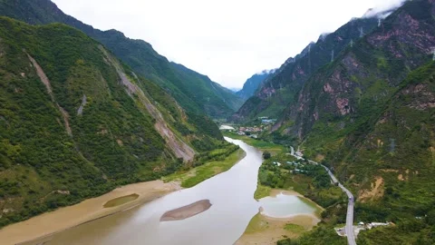 Aerial view of river branch tidal flat mountain town deep green mountain valley Video stock 337926815