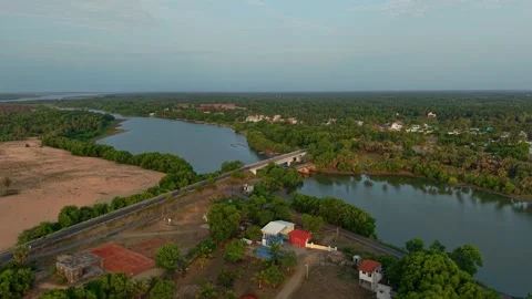 Aerial view of river with bridge and lush greenery near Chennai coastline at 動画素材 342713368