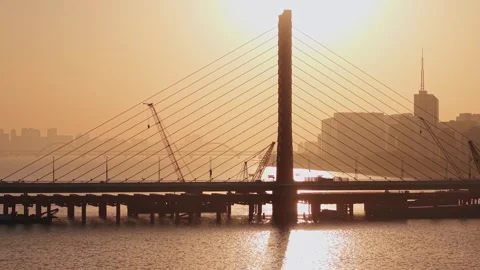 Aerial view of a river bridge construction at sunset in Hangzhou, China from Stock-Footage 325079885
