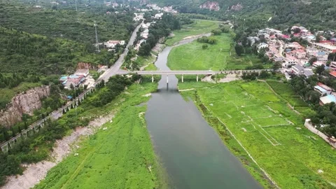 Aerial view of river bridge in lush valley. Stock Footage 336335360