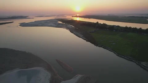Aerial View of River-Cut Sunset Landscape in Rural Bangladesh | 4K Drone Footage Stock Footage 314100025