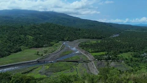 Aerial view of river diversion channel and farmland at the foot of Mayon Volcano Stock Footage 336971951