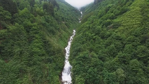 Aerial view of the river falling down between mountains Stock Footage 97547136
