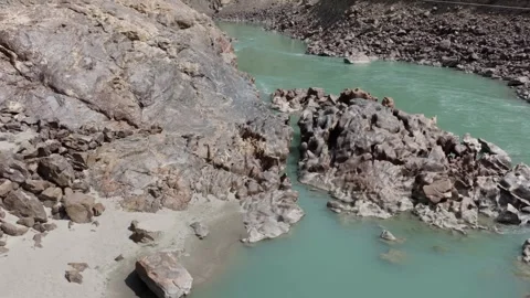 Aerial View of a River Flanked by Unique Rock Formations in Pakistan and a Woman Stock Footage 317957418