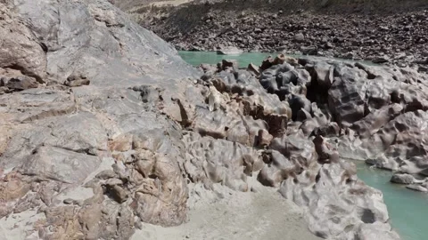 Aerial View of a River Flanked by Unique Rock Formations in Pakistan and a Woman 스톡 동영상 317958403