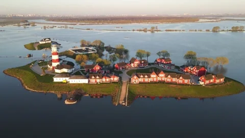 Aerial view of the river flood, lighthouse and fishing village Stock Footage 191006875