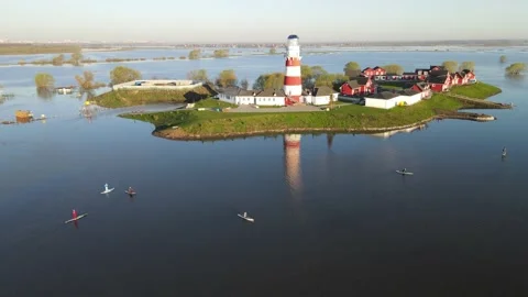 Aerial view of the river flood, lighthouse and fishing village Stock Footage 191009365