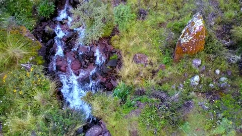 Aerial View of river flowing down the mountain Stock Footage 75747851