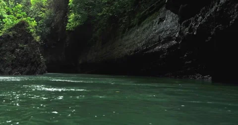 Aerial View of River Flowing Downstream Through Tropical Canyon Stock Footage 332489794