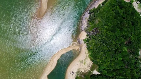An aerial view of river flowing into the ocean. Видео 79829412