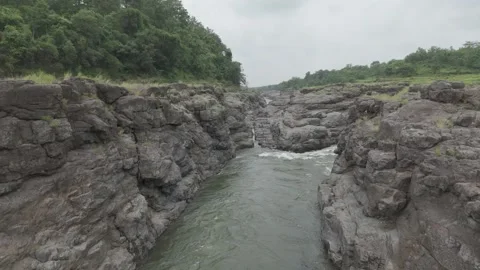 Aerial view of river flowing through the rock area. Video stock 285430296