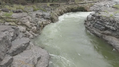 Aerial view of river flowing through the rock area. Video stock 285430446