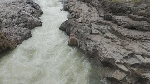 Aerial view of river flowing through the rock area. Video stock 285430464