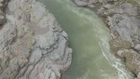 Aerial view of river flowing through the rock area. Video stock 285476053
