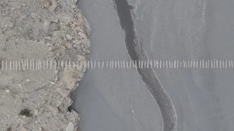 Aerial view of a river flowing through rocky terrain in Pakistan, showcasing 스톡 동영상 317958080