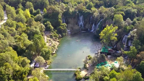 Aerial view of river flowing through forested landscape in Bosnia Stock Footage 324711876