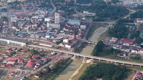 Aerial view of a river flowing through a small town Stock Footage 333053287