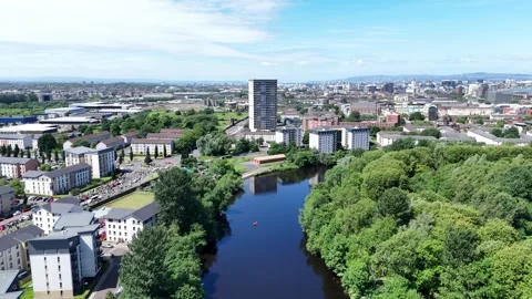 Aerial view of river flowing through urban cityscape with residential build.. Video stock 337639474