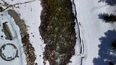Aerial View of River Flowing Through Snow Covered Land Stock Footage 341115220