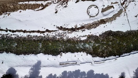 Aerial View of River Flowing Through Snow Covered Land Stock Footage 341115356