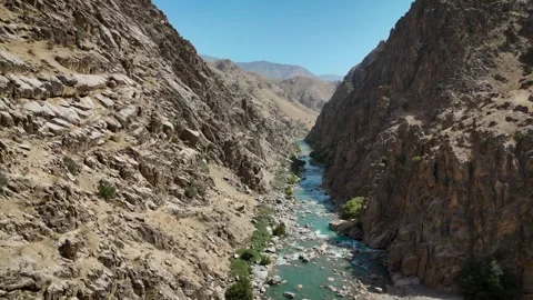 Aerial View of a River Flowing Through Rocky Canyon Stock Footage 343732337