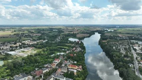 Aerial View of River Flowing Through Town and Fields Stock Photos