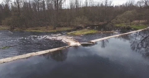 Aerial view. River flows through broken dam 動画素材 74955355