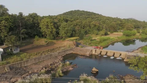 Aerial view of river in forest with the Check dam and tractor trailer. Stock Footage 254273554