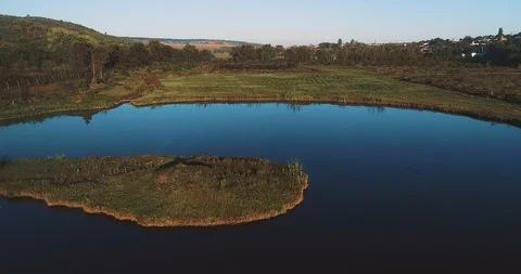 Aerial view of a river, green plain and a village. 스톡 동영상 114437342