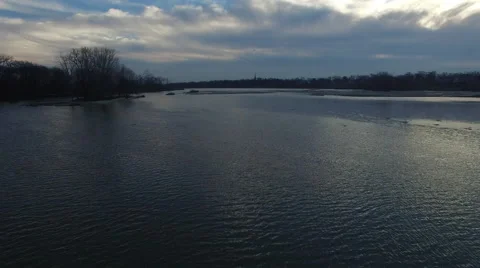 Aerial view of river from low angle close to water as geese fly in formation Stock Footage 60038223