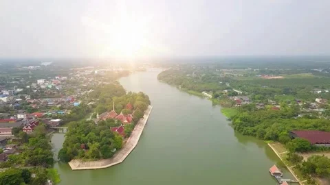 Aerial View of River Meandering Through Town at Sunrise Video stock 310324455