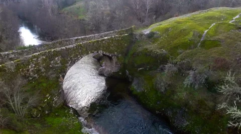 Aerial view of a river on a mountain, with an old bridge. Stock Footage 63361613