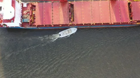Aerial View of River Pilot Disembarking from Cargo Ship to Pilot Boat Stock Footage 131691292