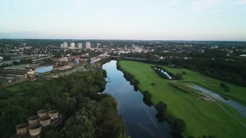 Aerial view of river running through the city with trees and fields on its banks Stock Footage 251138084
