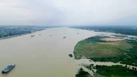  Aerial view of a river with small cargo ships navigating through the calm water Stock Footage 287772989