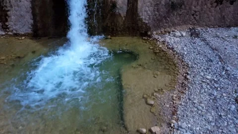 Aerial View of a River with a Small Waterfall and Pond Stock Footage 305235887