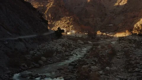 Aerial view of a river stream in the mountains in Kalash valley Pakistan Stock Footage 169837828
