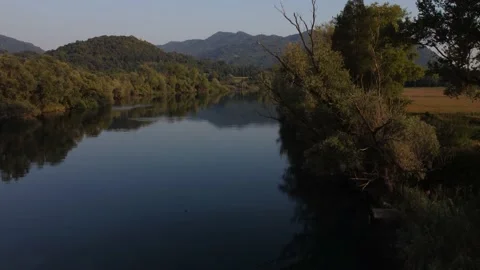 Aerial view of a river at sunset with ducks and mountains Stock Footage 160685495
