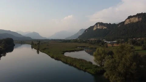 Aerial view of a river at sunset with ducks and mountains Stock Footage 160685532