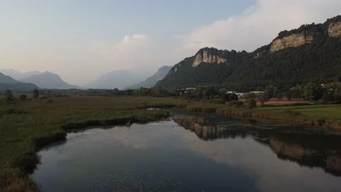 Aerial view of a river at sunset with ducks and mountains Stock Footage 160685536