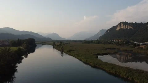 Aerial view of a river at sunset with ducks and mountains Stock Footage 160685607